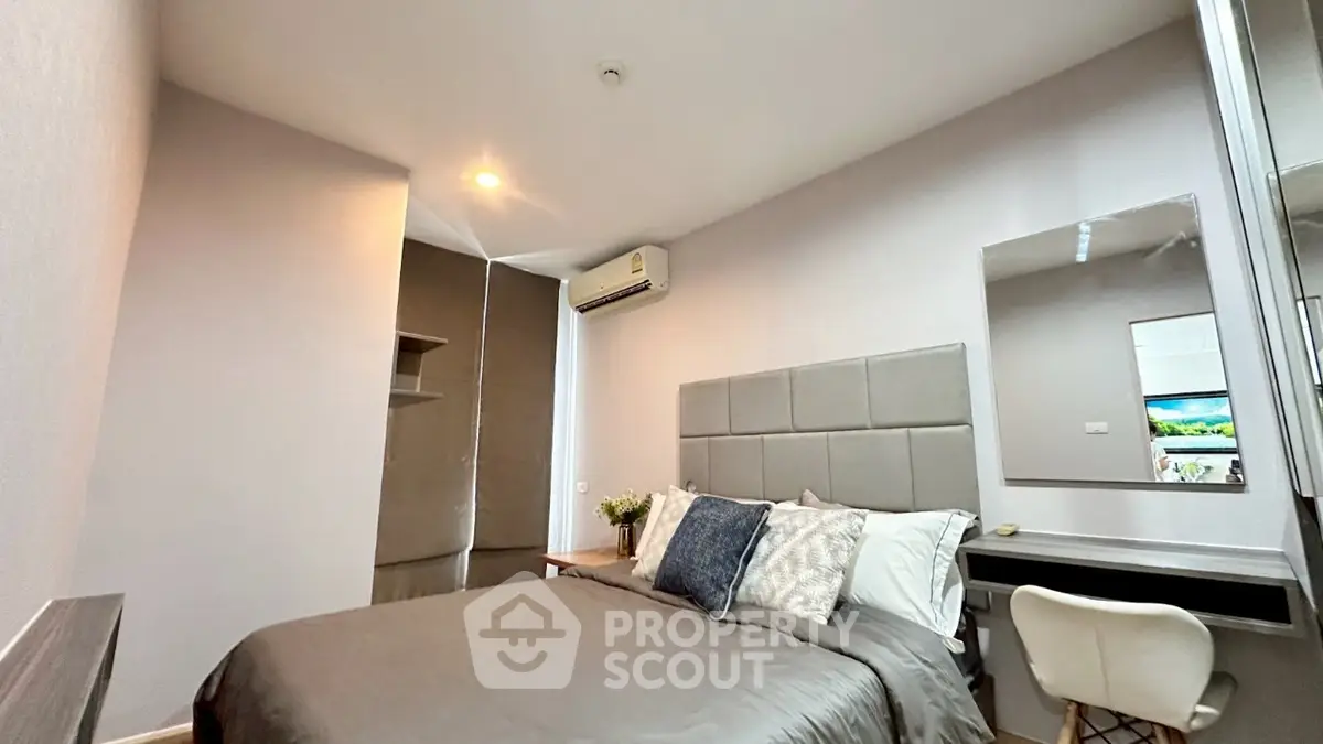 Modern bedroom with stylish decor and air conditioning in a cozy apartment.