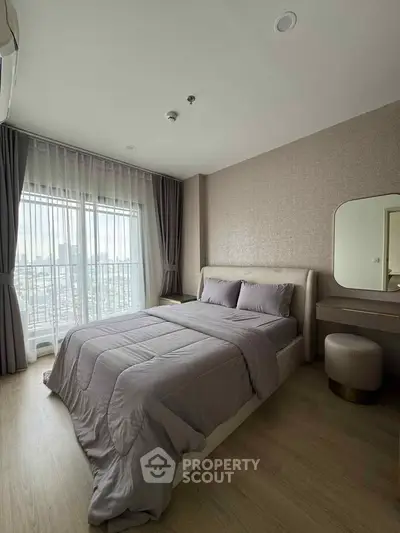 Modern bedroom with cozy bed, large window, and stylish decor in a high-rise apartment.