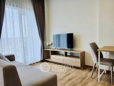 Modern living room with sleek furniture and large window for natural light.