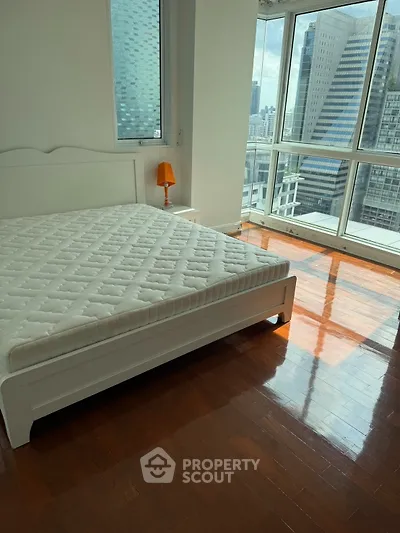 Spacious bedroom with city view and natural light in modern apartment