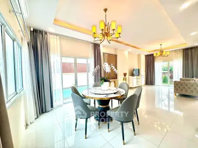 Spacious and elegant living room with modern dining area and large windows