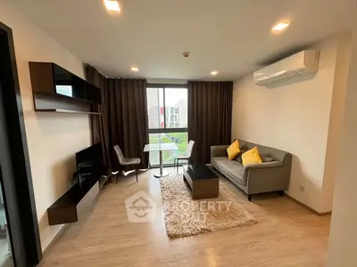 Modern living room with stylish furniture and large window view