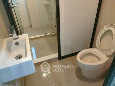 Modern bathroom with sleek fixtures and glass shower enclosure