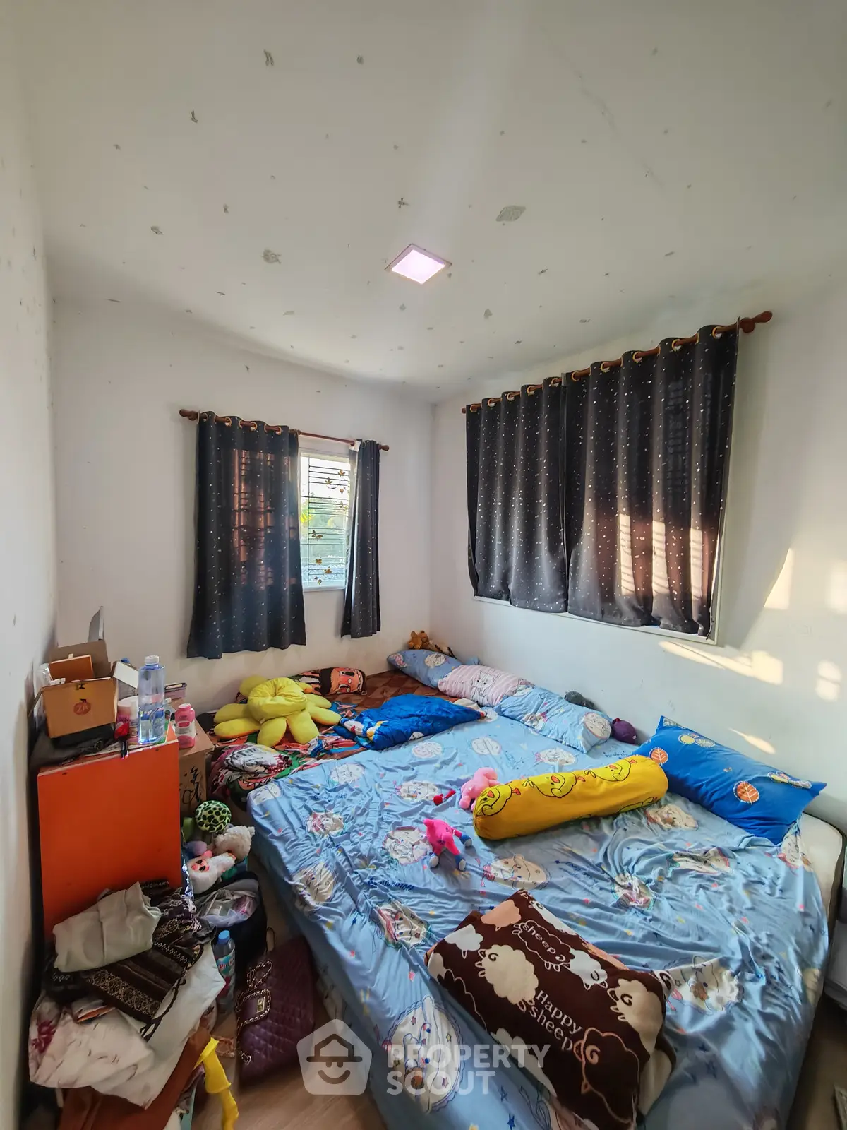 Cozy bedroom with double bed and natural light through window