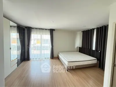 Spacious bedroom with large windows and modern decor