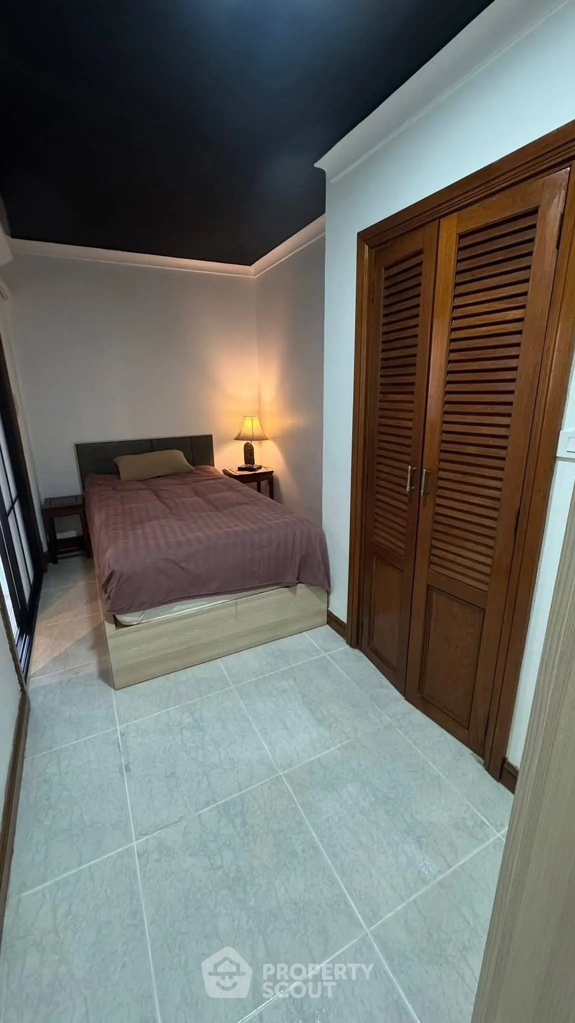 Cozy bedroom with wooden closet and ambient lighting