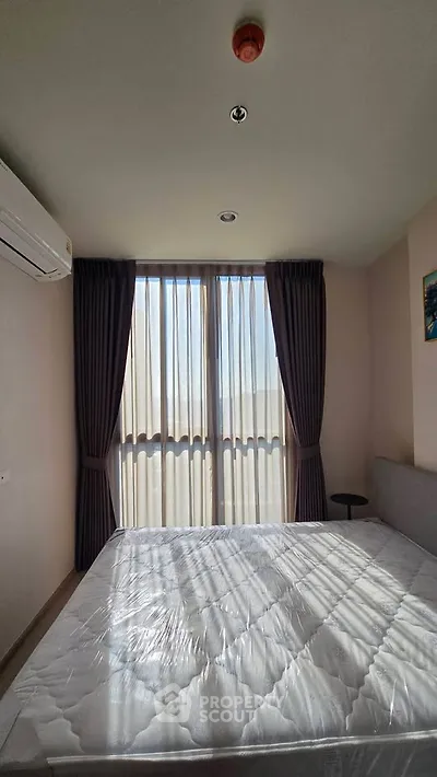 Bright bedroom with large window and modern furnishings