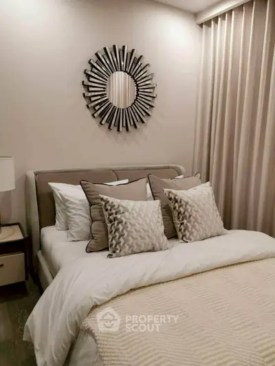 Elegant bedroom with stylish decor and plush bedding in modern apartment.