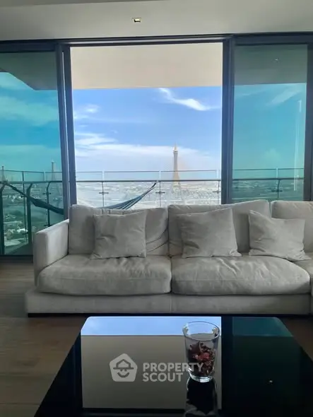 Luxurious living room with stunning city view and spacious balcony.