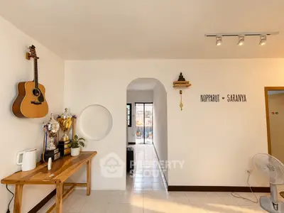 Charming interior with guitar, trophies, and modern decor in a cozy living space.