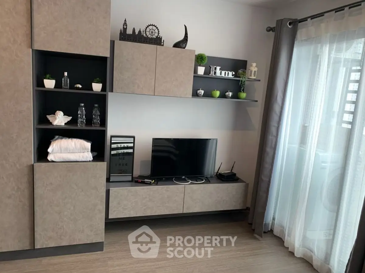 Modern living room with sleek TV unit and decorative shelves