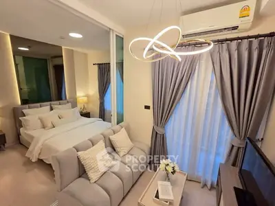 Modern bedroom with elegant lighting and cozy seating area, featuring floor-to-ceiling windows and stylish decor.