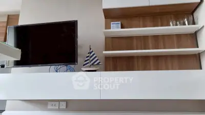 Modern living room with sleek TV setup and stylish shelving