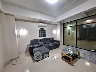 Spacious modern living room with sleek design and large glass doors