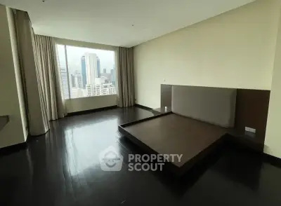 Spacious bedroom with city view and modern design in high-rise apartment