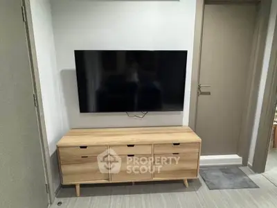 Modern living room with sleek TV setup and stylish wooden cabinet