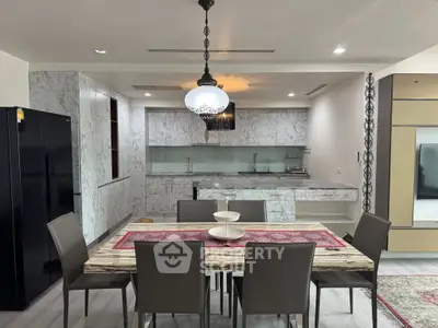 Luxurious modern kitchen with marble countertops and elegant dining area, perfect for entertaining guests.