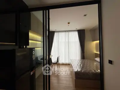 Modern bedroom with sliding glass doors and natural light
