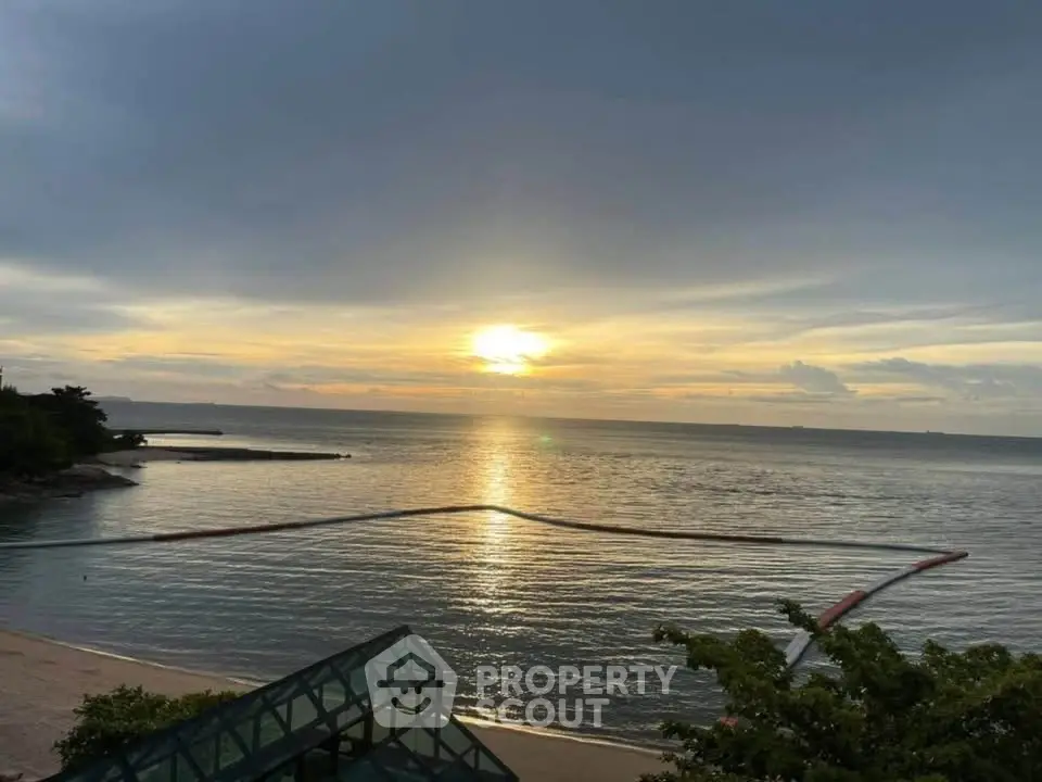 Stunning ocean view from beachfront property at sunset, perfect for serene living.