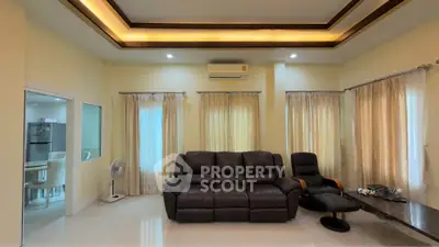 Spacious living room with elegant lighting and comfortable seating