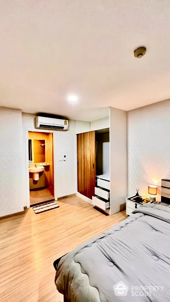 Modern bedroom with ensuite bathroom and stylish wooden flooring