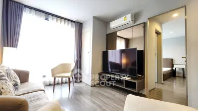 Modern living room with large TV and stylish furniture in a bright apartment