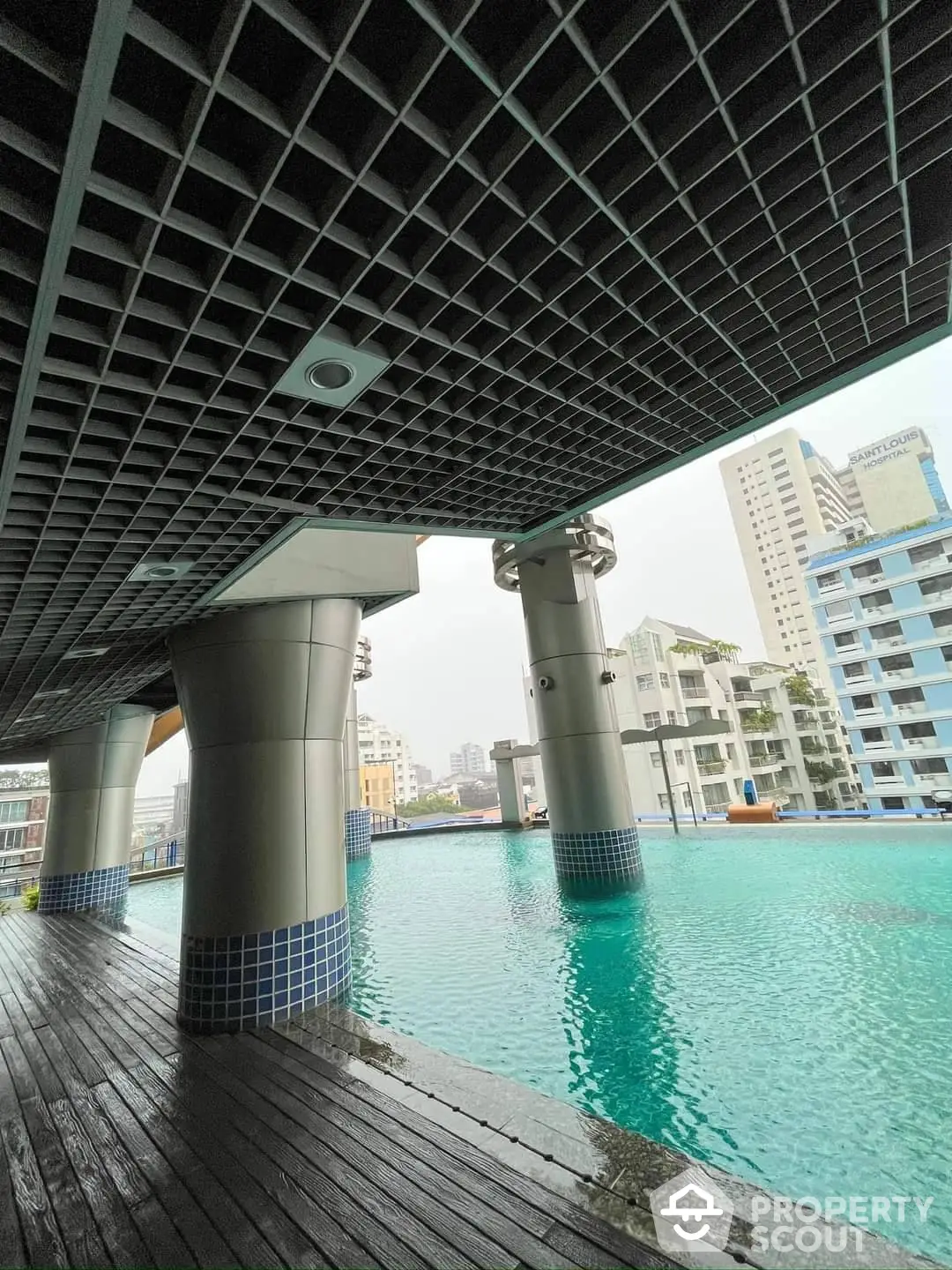 Unique urban oasis with an expansive pool under a modern building, offering a tranquil escape amidst the cityscape.