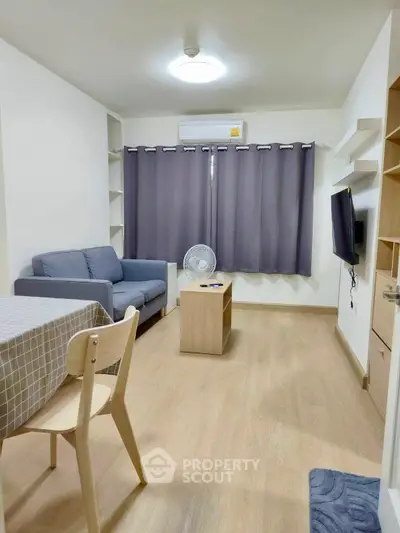 Cozy living room with modern furniture and natural light, perfect for relaxation and entertainment.