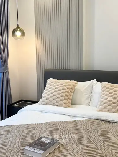 Elegant bedroom with modern decor, cozy bedding, and stylish lighting for a serene ambiance.