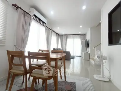 Spacious modern living room with dining area and natural light