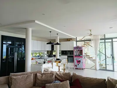 Luxurious open-plan living room with modern kitchen and spiral staircase