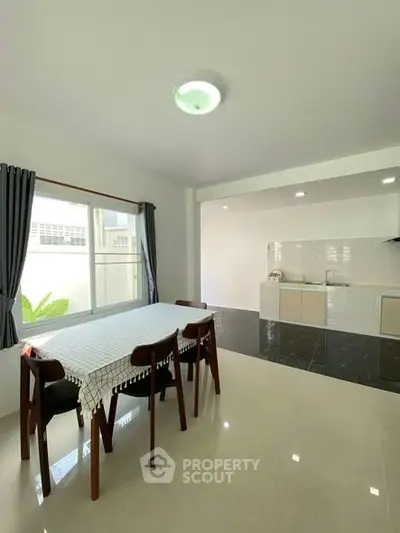 Spacious dining area with modern kitchen in open layout design