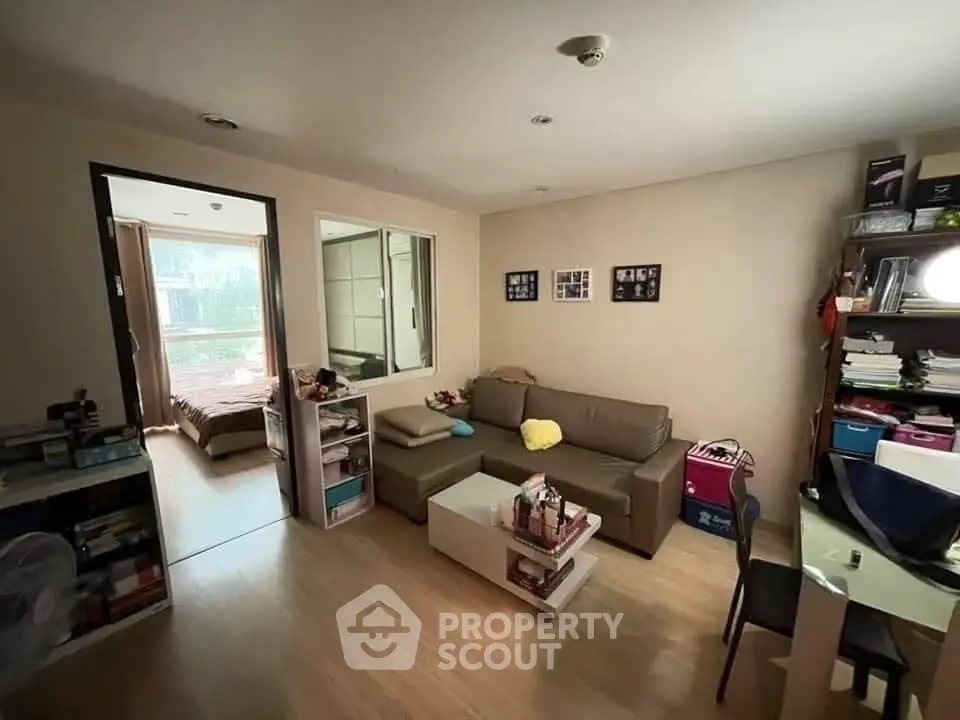 Cozy living room with modern decor and adjacent bedroom, perfect for urban living.