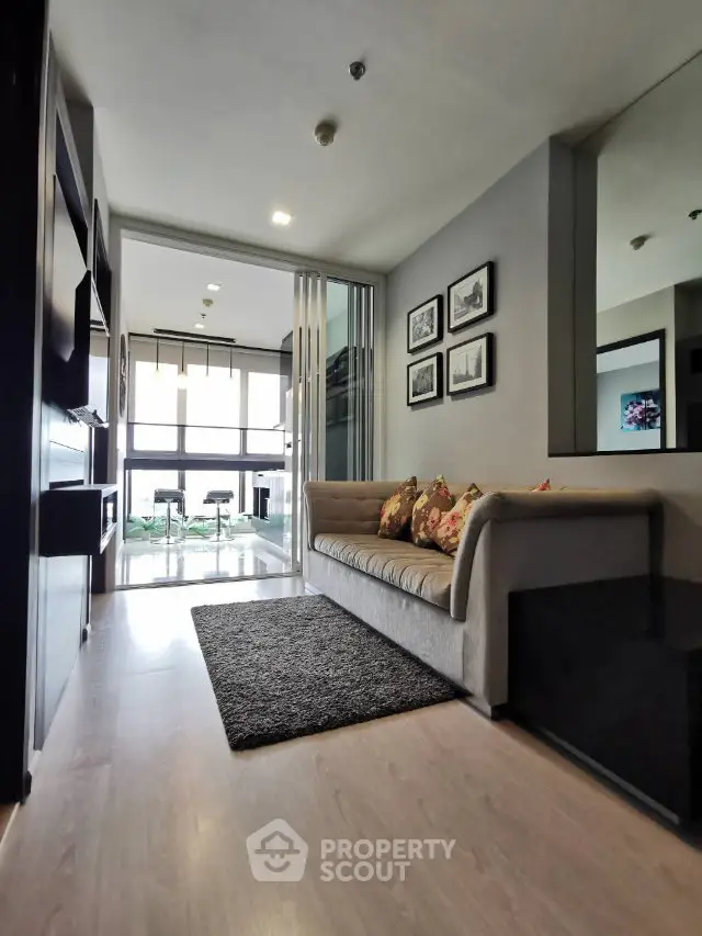 Modern living room with stylish decor and large windows offering natural light