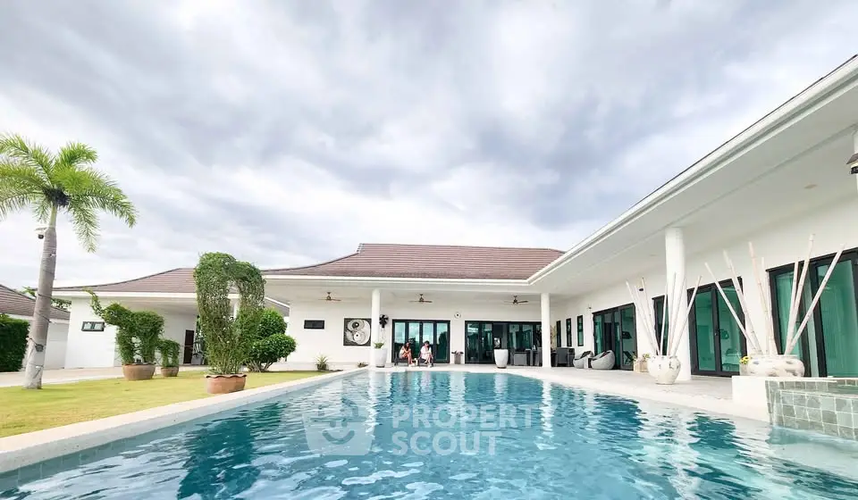 Luxurious modern villa with spacious pool and lush garden, perfect for relaxation and entertainment.
