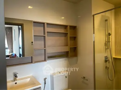 Modern bathroom with sleek fixtures and glass shower enclosure