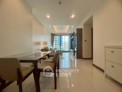 Spacious modern living room with dining area and city view, perfect for urban living.