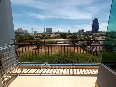 Spacious balcony with stunning cityscape view, perfect for relaxation and enjoying urban living.