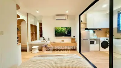 Modern studio apartment with open layout, featuring a cozy bed, sleek kitchen, and stylish decor.