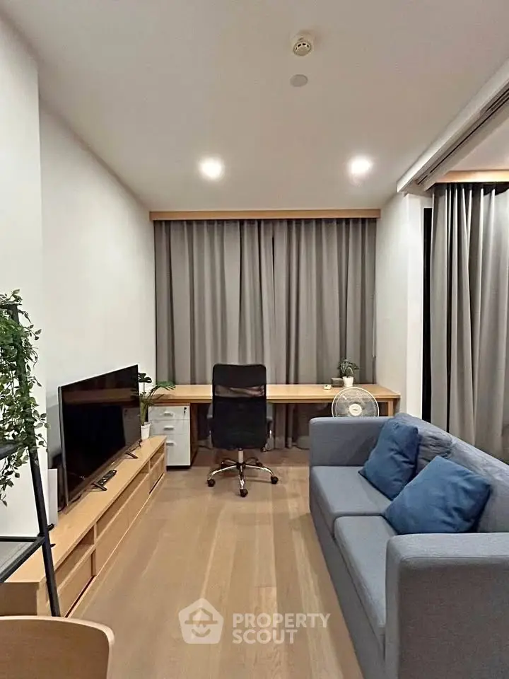 Modern living room with sleek furniture and cozy ambiance, perfect for relaxation and productivity.