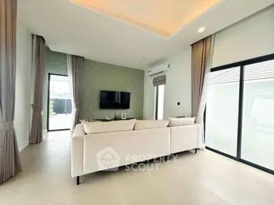 Spacious modern living room with elegant decor and large windows