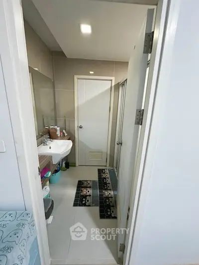 Modern bathroom with sleek design and essential amenities in a contemporary home.