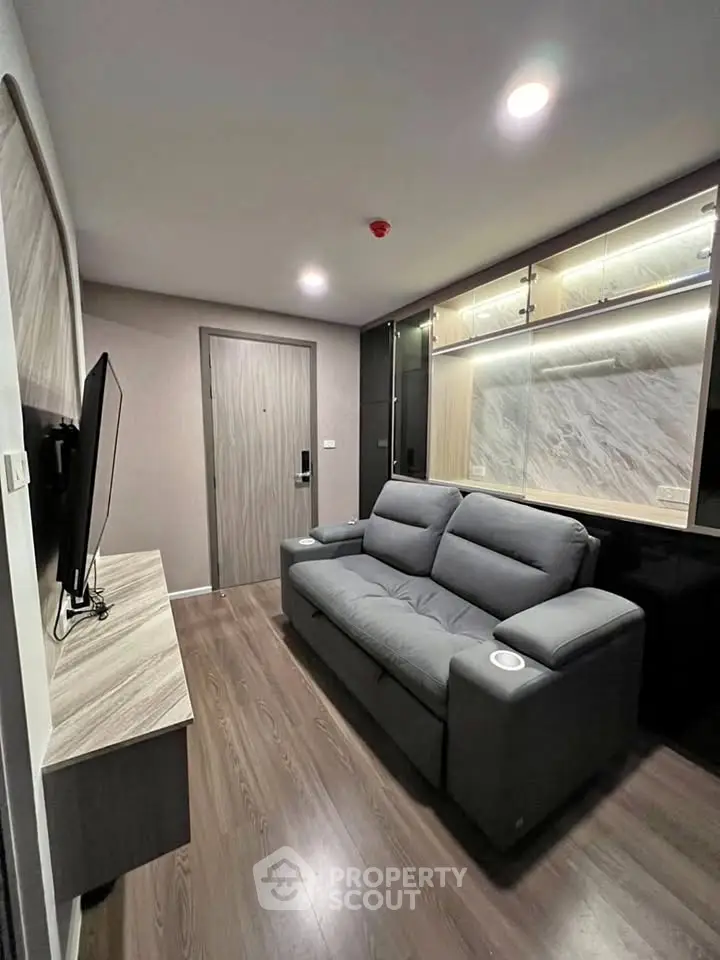 Modern living room with sleek design and comfortable seating in a stylish apartment.