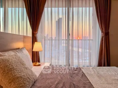Cozy bedroom with city view and warm sunset lighting