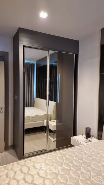 Modern bedroom with mirrored wardrobe and stylish decor