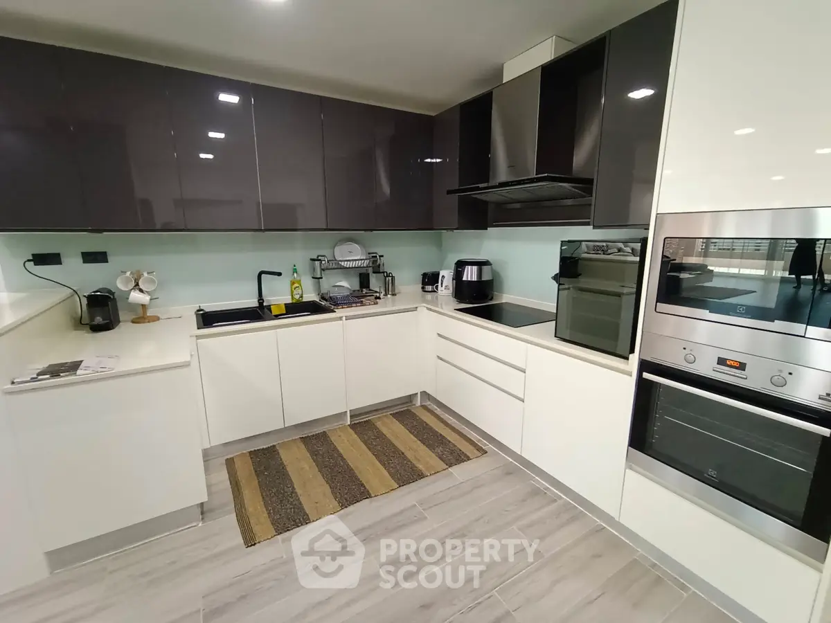 Modern kitchen with sleek cabinetry and built-in appliances, featuring a stylish open layout.