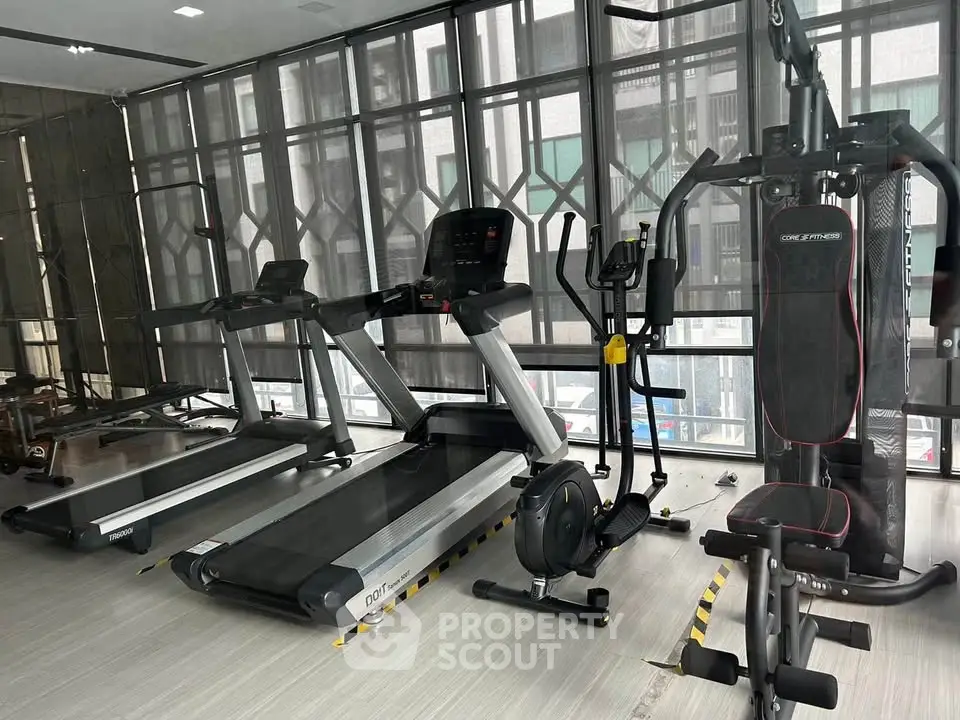 Modern gym with state-of-the-art fitness equipment and sleek design.