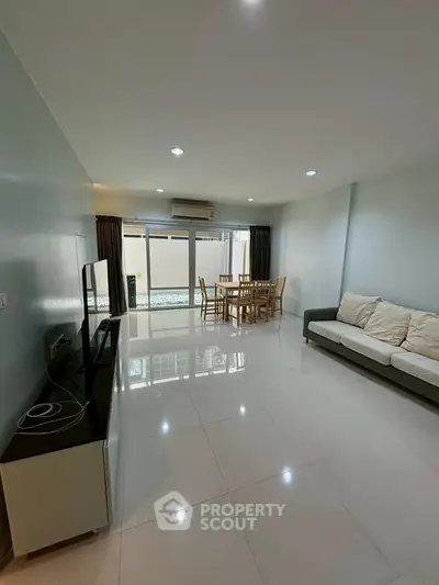 Spacious living room with modern furniture and large windows for natural light.