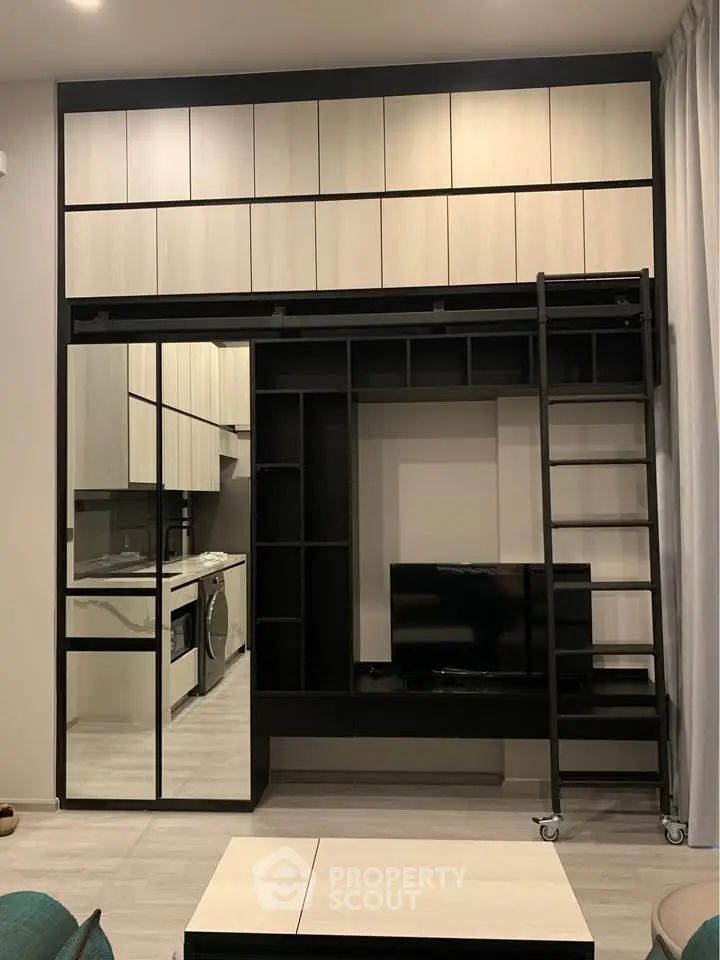 Modern living room with sleek storage, TV unit, and washing machine in compact design.