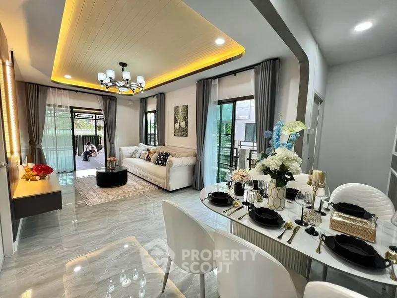 Luxurious modern living room with elegant dining area, featuring stylish decor and ample natural light.
